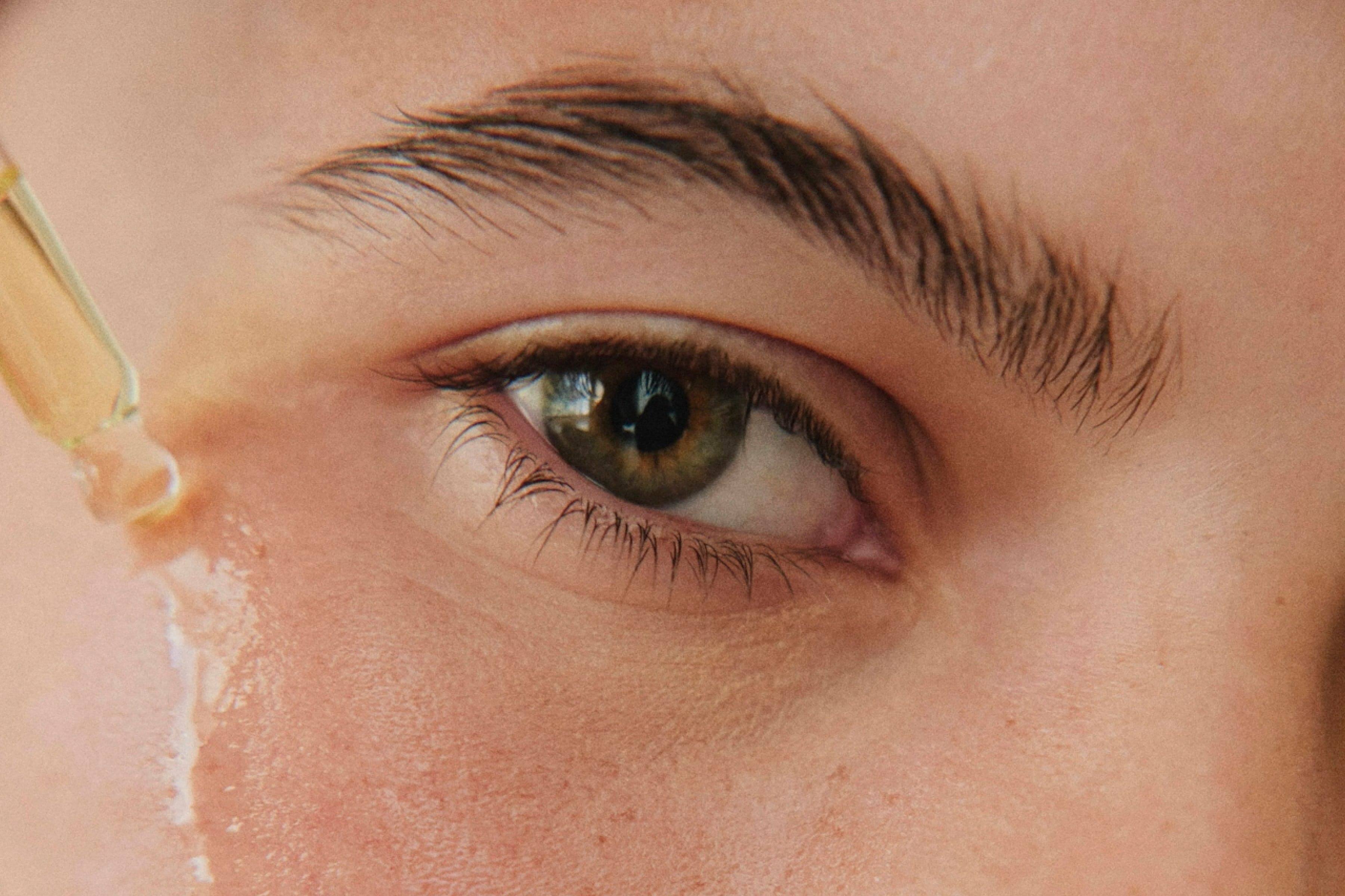 eye with skincare serum