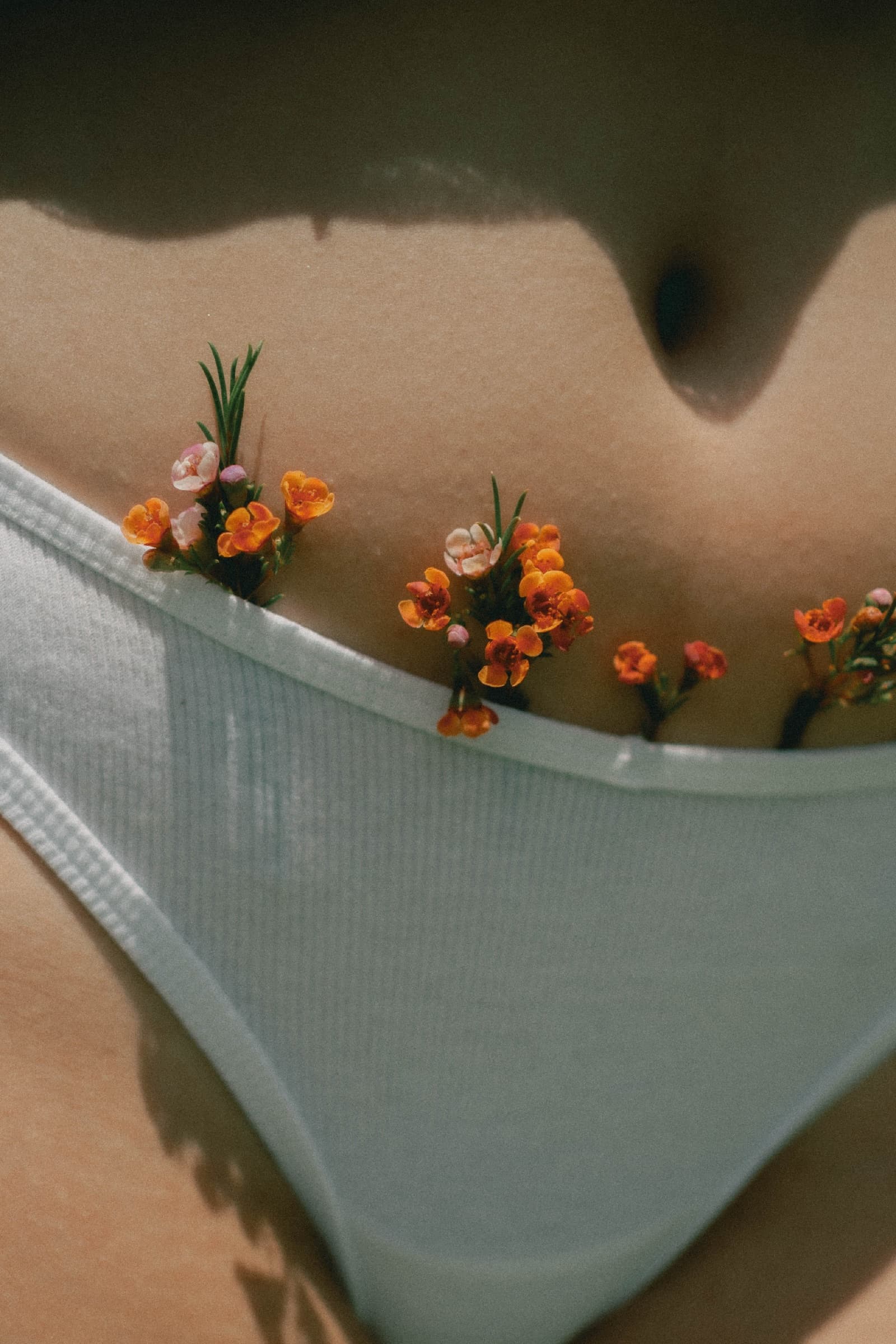 Small orange flowers tucked into white cotton underwear